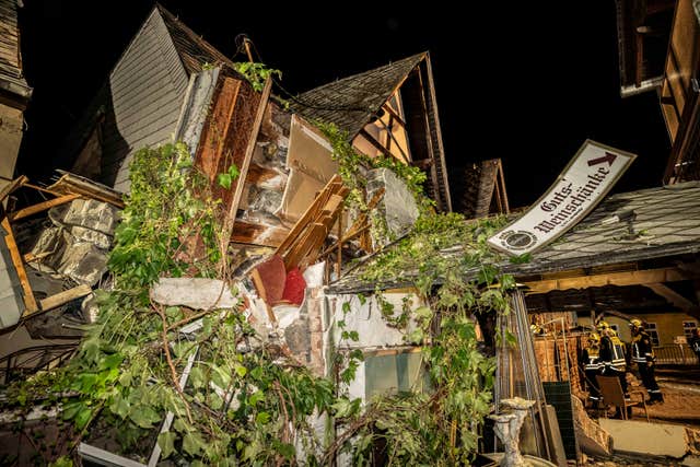 Debris from the collapsed hotel as firefighters work on the scene