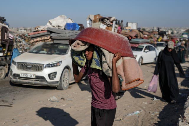 A Palestinian youth flees the Khan Younis area of the Gaza Strip following Israeli military evacuation orders 