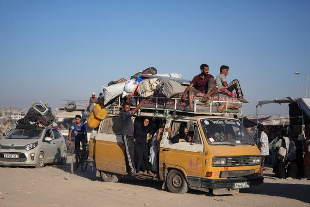 Palestinians flee on an overcrowded bus