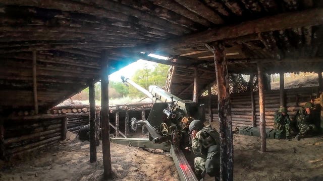 A Russian soldier fires a D-30 howitzer towards Ukrainian positions