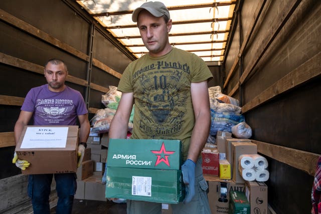 Volunteers at a temporary residence centre in Kursk, Russia, unload humanitarian aid for people evacuated from fighting between Russian and Ukrainian forces in the Kursk region