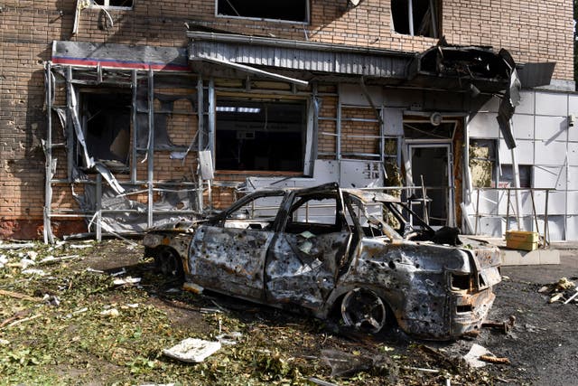 A burned car is seen in front of an apartment building damaged after shelling by the Ukrainian side in Kursk, Russia