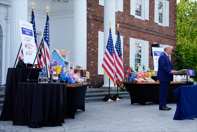 With consumer goods placed on tables near him, Republican presidential nominee Donald Trump speaks at a news conference (Julia Nikhinson/AP)