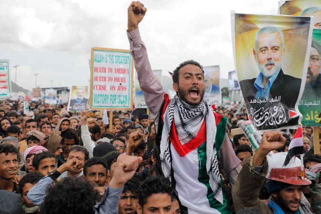 Houthi supporters hold posters showing Ismail Haniyeh, a Hamas leader assassinated in Tehran during an anti-Israel and anti-American rally in Sanaa, Yemen