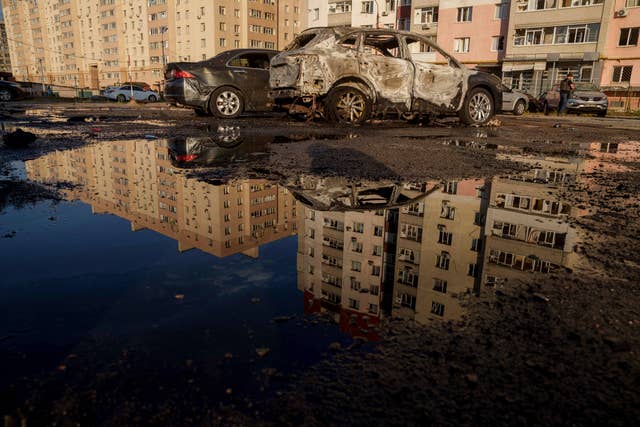 Destroyed cars are reflected in a pool of water after a Russian air strike on a residential neighbourhood in Sumy, Ukraine