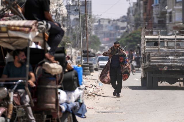 A man carrying his belongings along a road