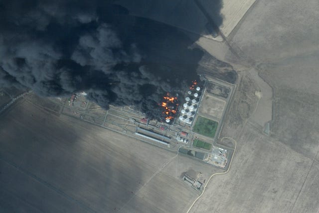 This satellite photo from Planet Labs PBC shows a fire at an oil depot earlier hit by a drone attack near Proletarsk, Russia, on Monday