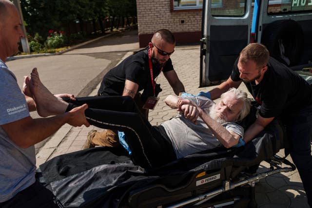 Volunteers on East SOS move an elderly disabled man on a stretcher during evacuation in Pokrovsk, Donetsk region, Ukraine 