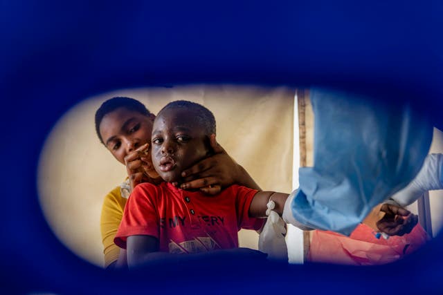 A health worker attends to an mpox patient at a treatment centre in Munigi