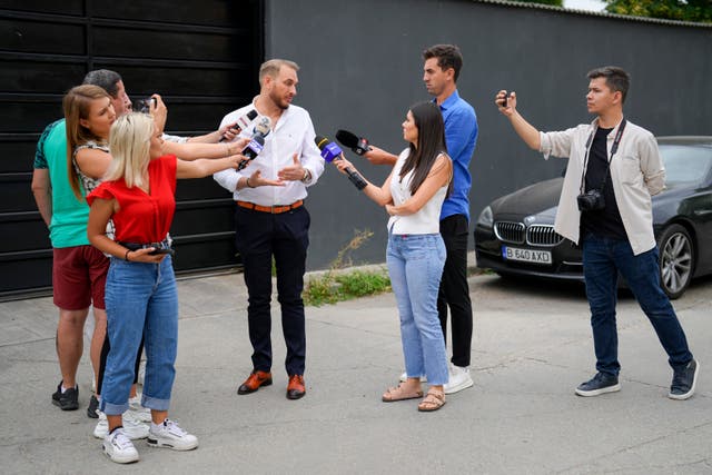 Internet influencer Andrew Tate’s lawyer Eugen Vidineac talks to the media during an early morning search raid by the police on the outskirts of Bucharest, Romania