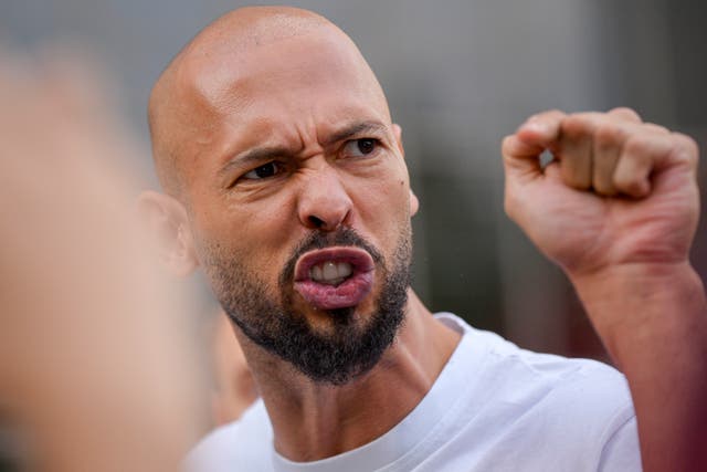 Head shot of a man with a beard raising his fist