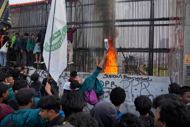 Protesters attempt to storm Indonesia’s parliament during a protest against controversial changes to election laws