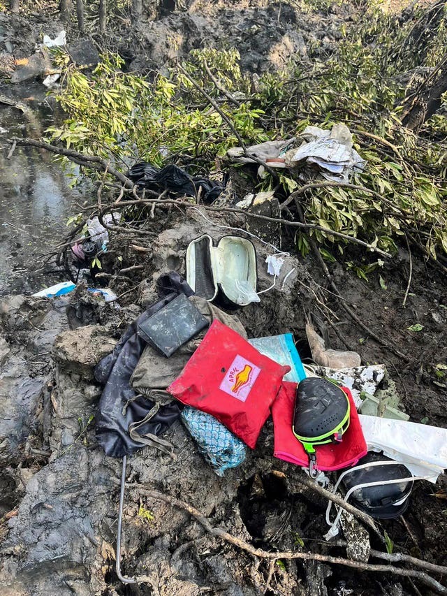 Passengers’ belongings are seen at the crash site in Chachoengsao province Thailand