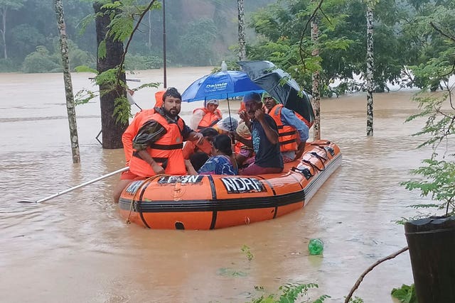 Rescuers transport people to safety in north-eastern Tripura state