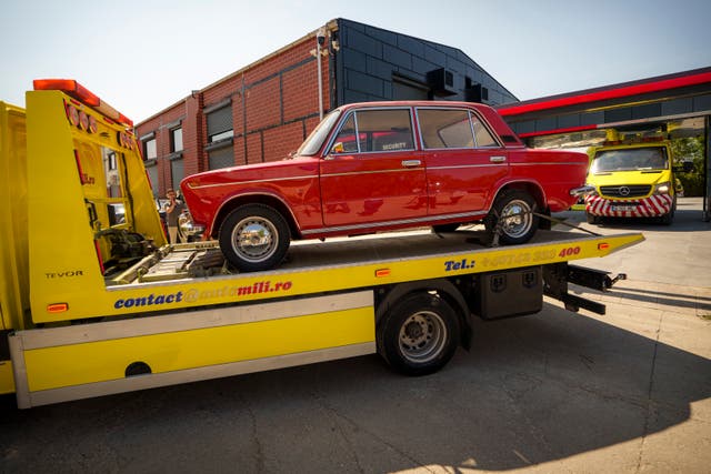 A red car on a low loader