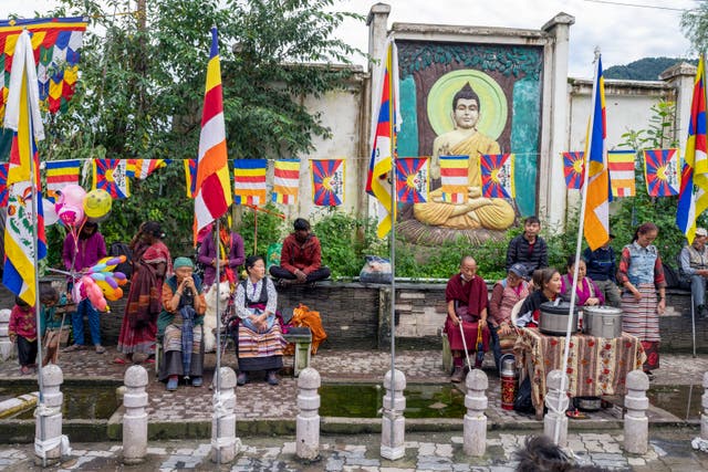 People wait for the Dalai Lama