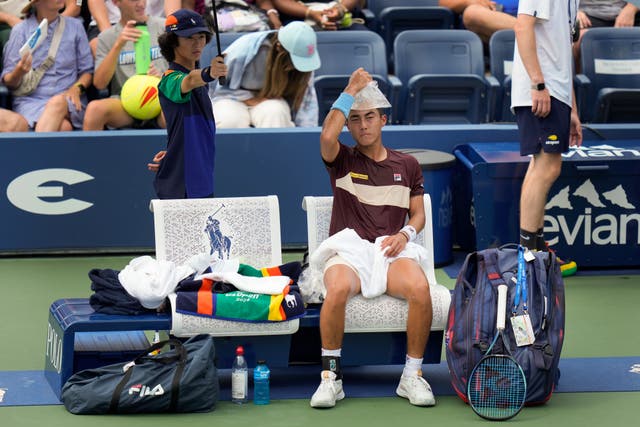 Ricky Hijikata puts a bag of ice on his head