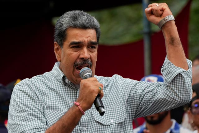 Venezuela’s President Nicolas Maduro addresses government loyalists gathered at the presidential palace in support of his re-election 