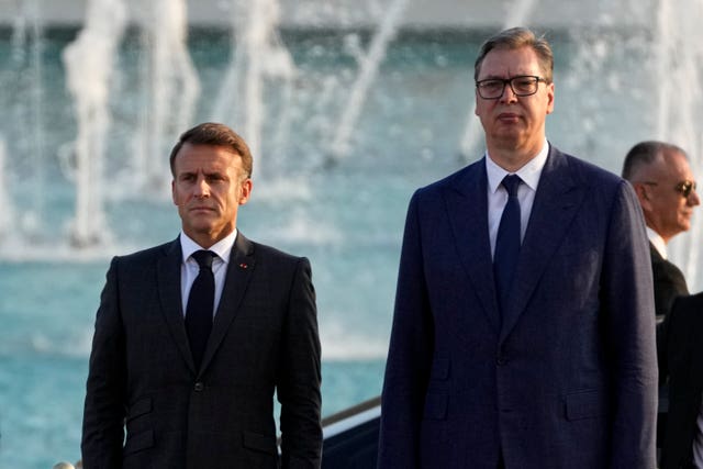 French President Emmanuel Macron, left, and Serbian President Aleksandar Vucic stand during a welcoming ceremony in Belgrade, Serbia