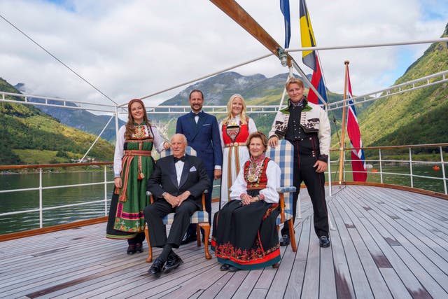 Norway’s King Harald, Queen Sonja, front, Crown Prince Haakon, rear center left, Crown Princess Mette-Marit, rear center right, Princess Ingrid Alexandra and Prince Sverre Magnus aboard the Kingship Norway in the Geirangerfjord