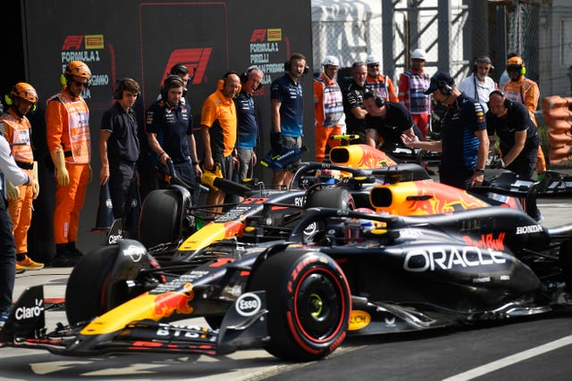 Max Verstappen's car, front, in the Red Bull pit box alongside that of Sergio Perez