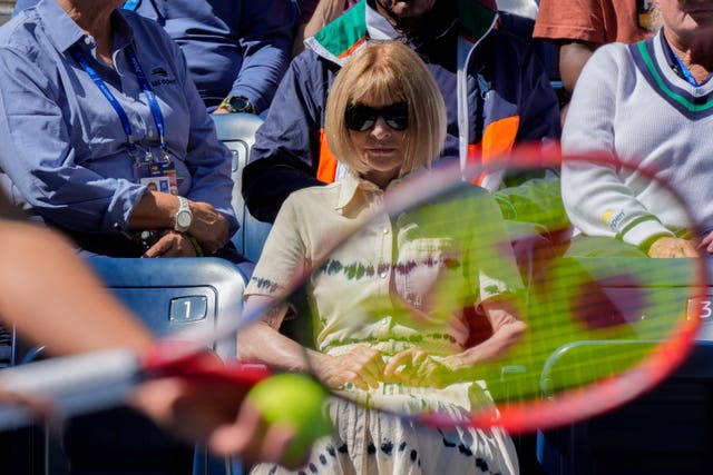 Anna Wintour watches on from the side