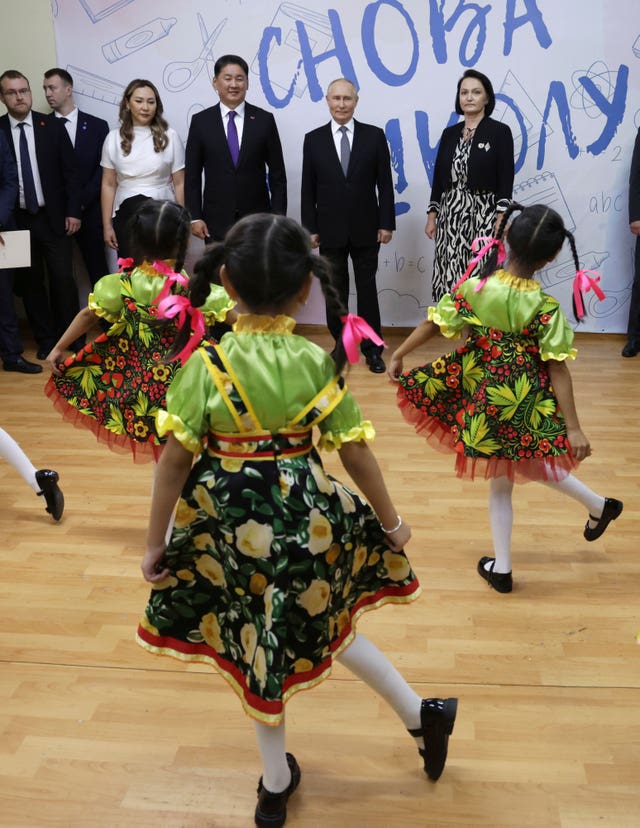 Russian President Vladimir Putin, centre right, and Mongolian President Ukhnaagiin Khurelsukh visit a school of the local branch of Plekhanov Russian University of Economics in Ulaanbaatar, Mongolia 