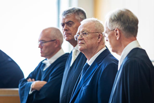 Four men in blue suits