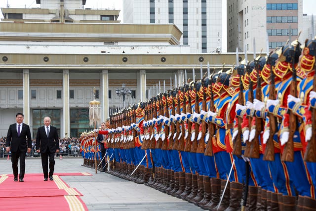 Russian President Vladimir Putin and Mongolian President Ukhnaagiin Khurelsukh, left, attend a welcome ceremony in Sukhbaatar Square in Ulaanbaatar, Mongolia 