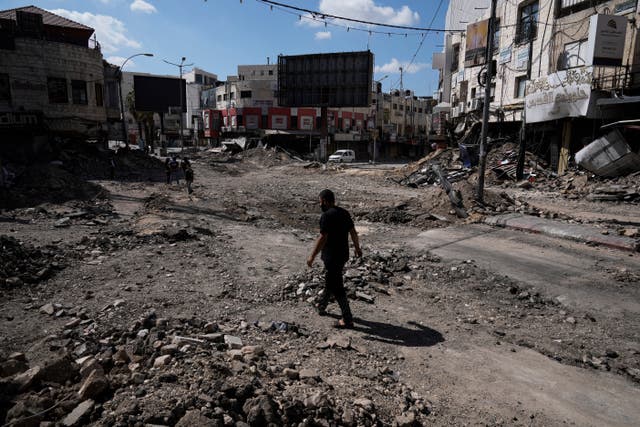 People walking through rubble following an Israeli army raid in Jenin