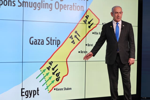 Benjamin Netanyahu gestures in front of a map