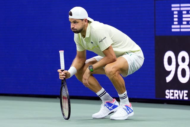 Grigor Dimitrov crouches down in pain 