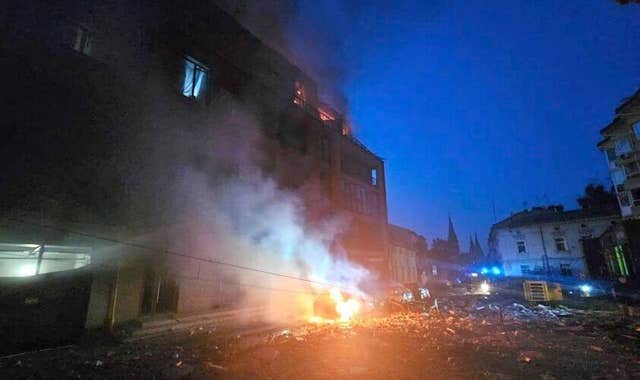 A car burns near a residential building damaged by a Russian strike in Lviv,