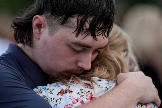 Mourners pray during a candlelight vigil for the students and teachers killed at Apalachee High School in Georgia