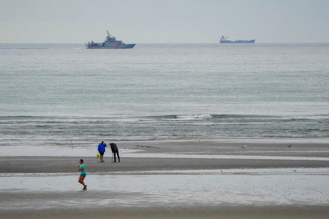 A vessel of the French Gendarmerie Nationale patrols in front of the Wimereux beach, France