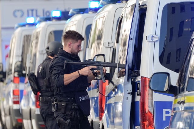 Police officers stand next to their vehicles after the incident in Munich 