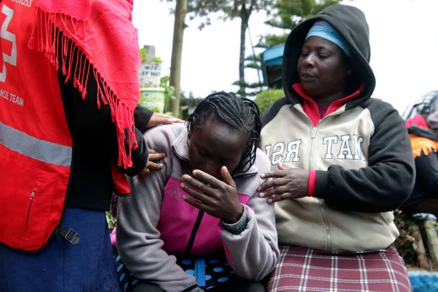 Kenya Red Cross personnel comfort a woman