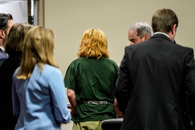 Colt Gray, 14, is escorted out of court. Seen from behind