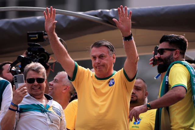 Former Brazilian President Jair Bolsonaro waves to supporters