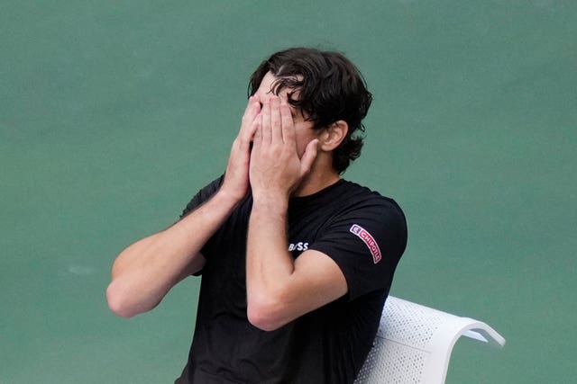 Taylor Fritz covers his face in disappointment