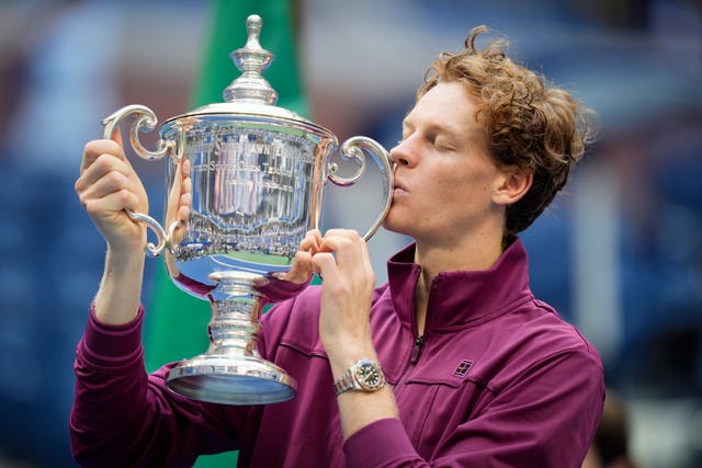 Jannik Sinner kisses the US Open trophy