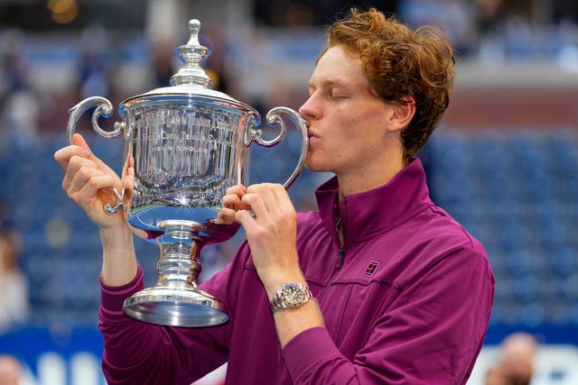 Jannik Sinner kisses the championship trophy after winning the 2024 US Open 