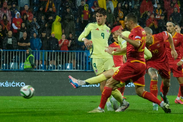 Kieffer Moore strokes home Wales' opening goal