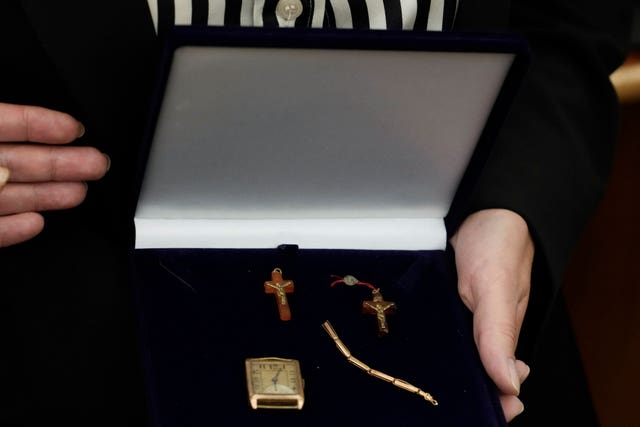 A relative shows amber crucifixes and jewelry that were confiscated by Nazi Germans from Stanislawa Wasilewska