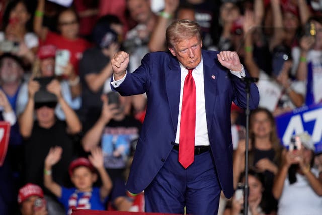 Donald Trump dancing on stage during a rally