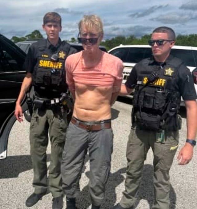 Police officers arrest Ryan Routh