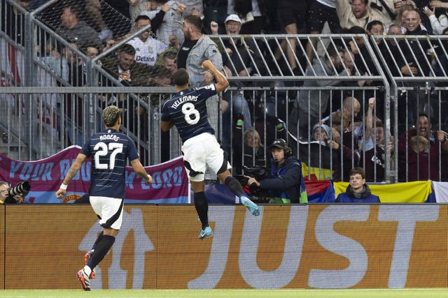 Youri Tielemans, right, leaps into the air with his fist clenched to celebrate scoring Aston Villa's first goal against Young Boys