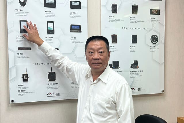 Hsu Ching-kuang, chairman of Apollo Gold, points to a picture as he talks about the company’s products dzzdyzeqzydzzyzdzzyezdzyzzxzyzqkeyxzzzinv eiqeeiqqtirdprw