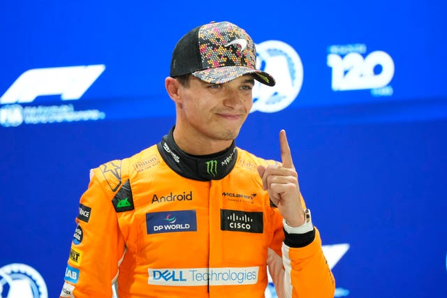 Lando Norris points to acknowledge his pole