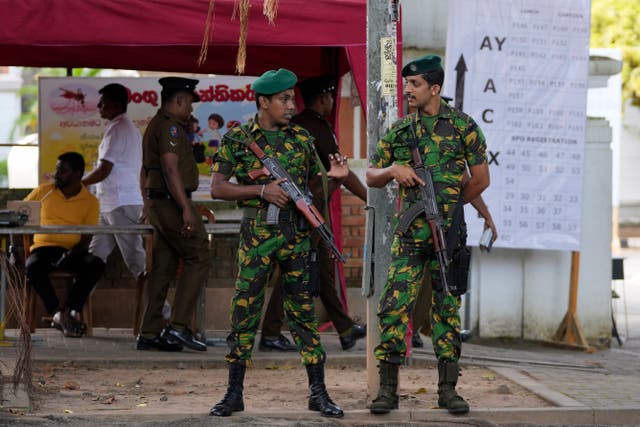 Police commandos stand guard outside a ballot counting centre